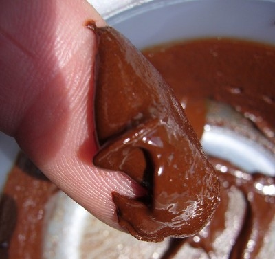 Consistency testing with a finger of a hazelnut spread.