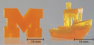 Solid block M (L) and tug boat (R) printed using the two-color photopolymerization/photoinhibition stereolithography system at 500 and 375 mm/hour, respectively