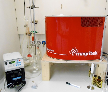 Spinsolve NMR spectrometer set up in a fume hood to monitor a batch reaction.