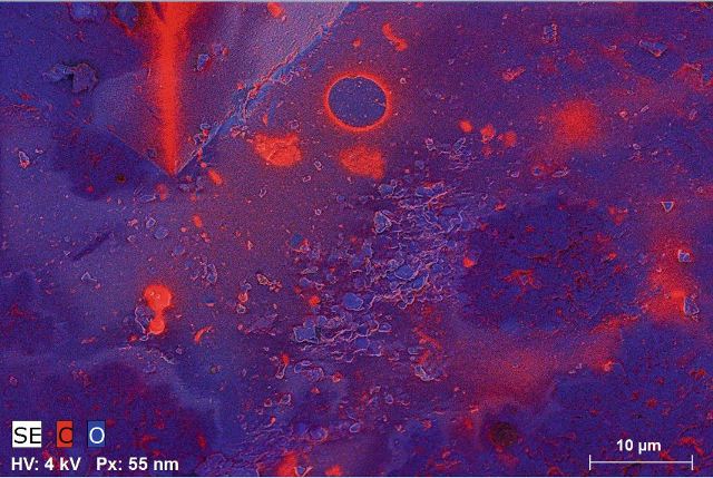 Tissint Martian meteorite; (a) the composite map of carbon and oxygen overlaid with the SE micrograph shows a thin coating and local enrichment of carbon on a silicate surface. (b) The distribution of nitrogen with low intensities can be made visible by using a false color display of the according map