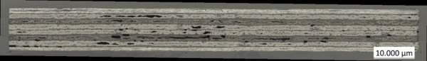 Stitched overview tile image of the CFRP cross-section, 100×, coaxial light