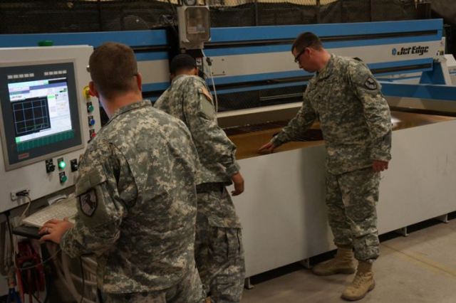 SPC Roberts, SPC Hodge and PFC Adams are cutting a part that that was built using the SigmaNEST® software.