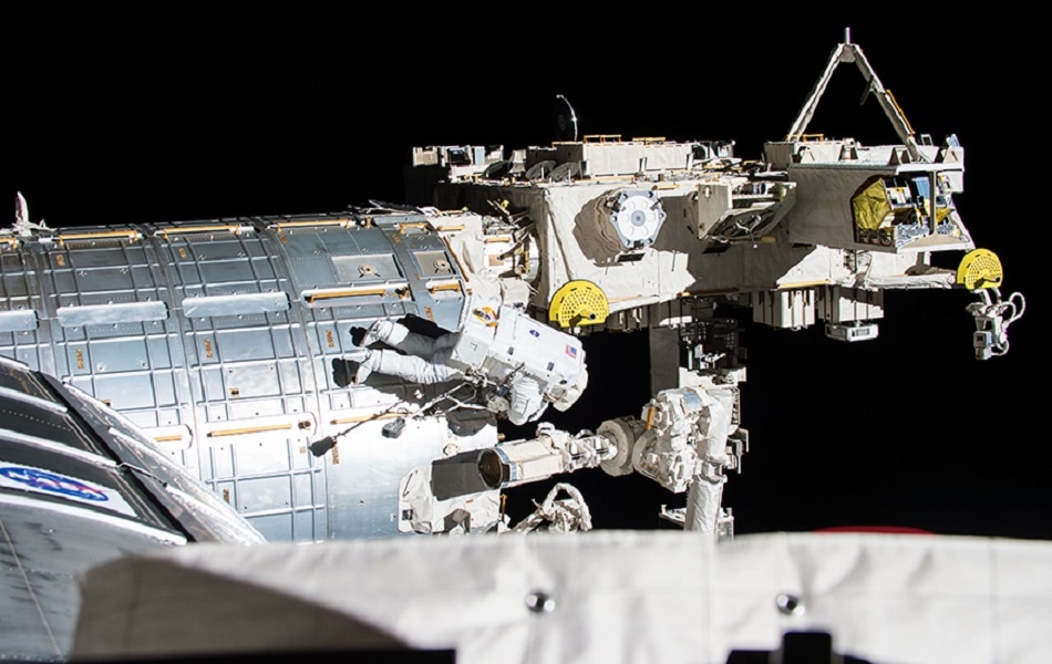 An astronaut performing maintenance tasks during a spacewalk outside the ISS. Credits: NASA/JSC.