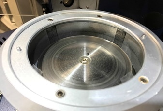 Removable chamber with adhesive strips for particle collection during different stages of testing.