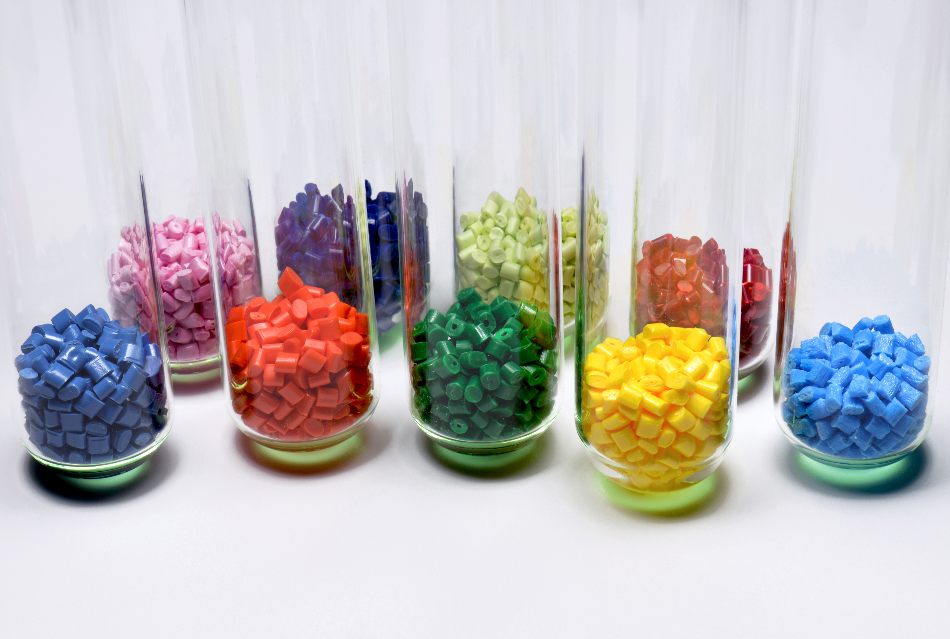 several dyed polymer resins in test glasses in laboratory