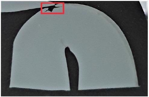 Cross section of a bend tested steel. The crack, propagated on the outer radius, is highlighted in red.
