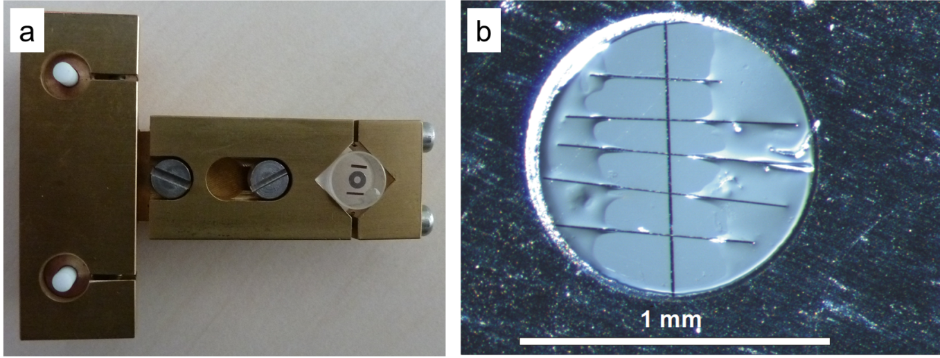 a) Photography of the T-Tool developed at HMI/HZB, with a glass cylinder attached to it, on top of which the specimen is clued by use of hot wax. b) Light micrograph of the inner part of a Mo support ring, showing the interface region (black vertical line in the middle of the image) with the glass substrates of the thin-film stacks on either side, as well as carbon fibers glued across the interface region of the cross-section.