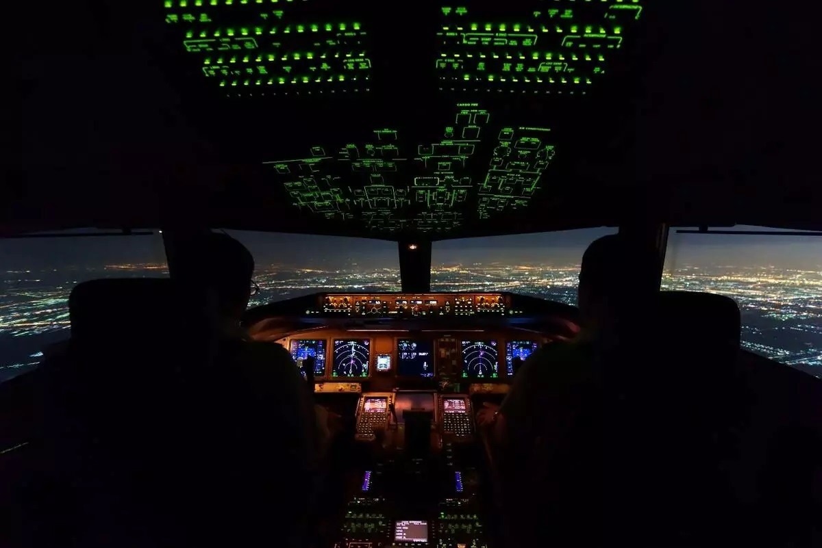 Modern pilots rely on an array of backlit indicators and controls alongside various displays in the cockpit of a Boeing passenger jet.