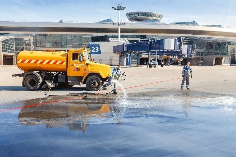 Workers cleaning airport truck