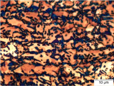 Micrograph, produced by heat tint etching, of TRIP 780 steel. The beige and orange areas are ferrite, the blue areas are martensite, and the dark blue/purple regions are retained austenite6.