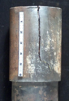 Grade P110 coupling failure that initiated at mechanical damage, shown at the top.