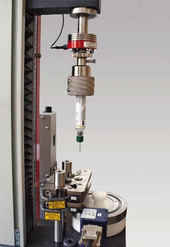 A zwicki-Line system engaged in characterization of an injection device. Specialized fixturing holds the specimen in position for a variety of different tests in accordance with customer requirements.