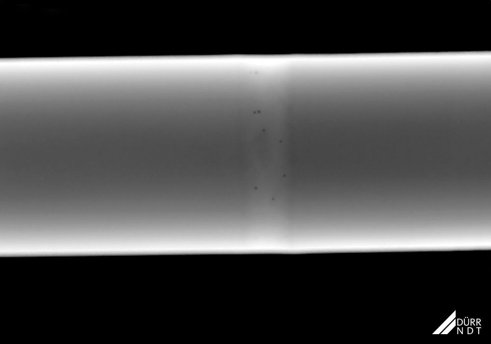 Weld seam with multiple pores, Ø 13 mm titanium pipe, X-ray, perpendicular technique.