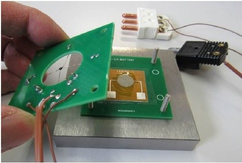 Placing top cover over UV Cure Sensor after application of resin