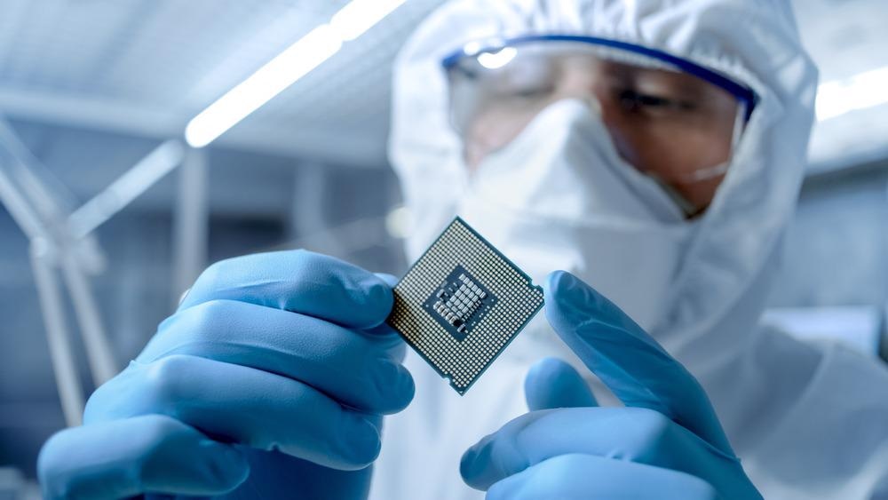 scientist holding microchip semiconductor