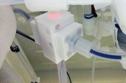 Non-invasive clamp-on flow cell with optical fibers (in blue) attached to the wet bench circulation stream. Note the protective and purged tube around the fiber, preventing corrosion.